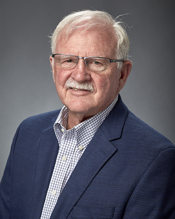 man in a blue jacket wearing eye glasses